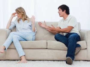 Couple arguing on sofa